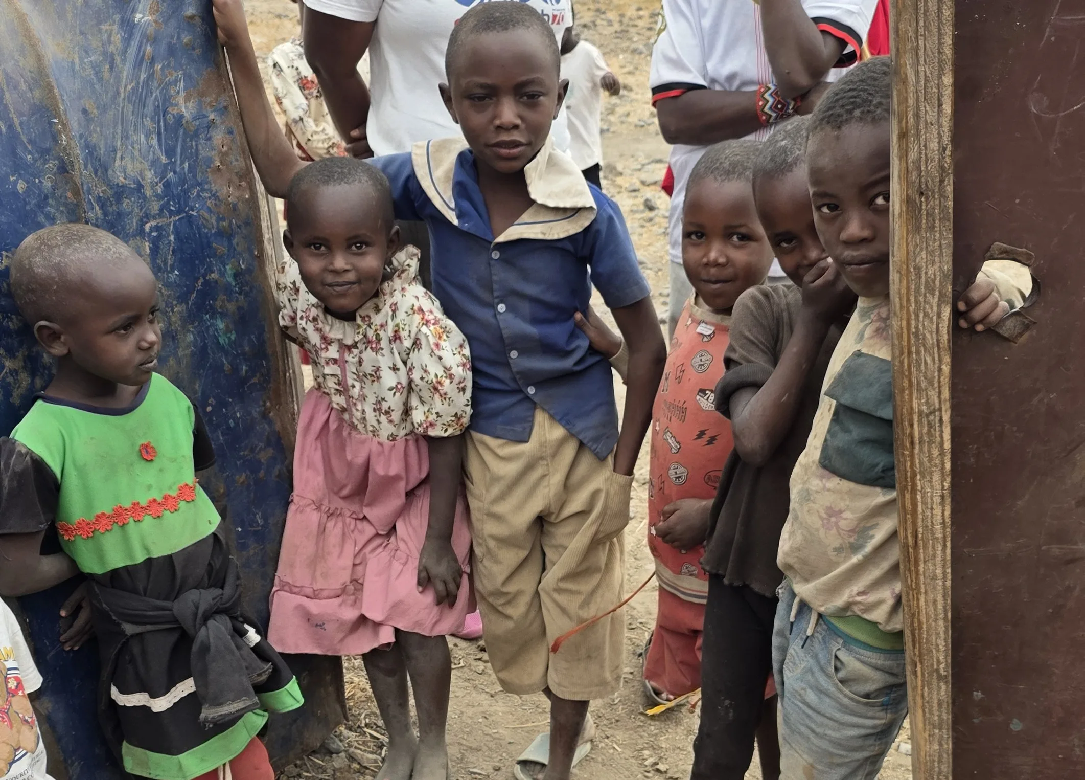 Local Maasai children gathered in a doorway